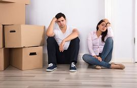two people frustrated from packing up their house