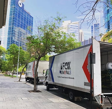 Fox Removals truck parked in the city outside an office building