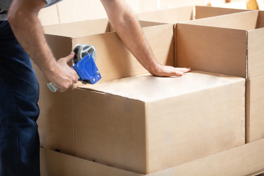 someone packing a box ready to move house